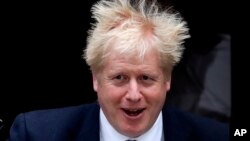 Britain's Prime Minister Boris Johnson leaves 10 Downing Street to attend the weekly Prime Ministers' Questions session, in parliament in London, Wednesday, Oct. 23, 2019. 