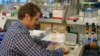 Researcher Jimmy O'Donnell at the University of Washington lab bench where he processes eDNA samples. (VOA / T. Banse)