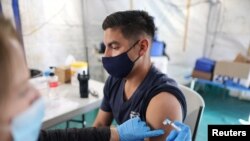 Orange County firefighter Christopher Huerta receives the COVID-19 vaccine in Irvine, Calif., Jan. 27, 2021.