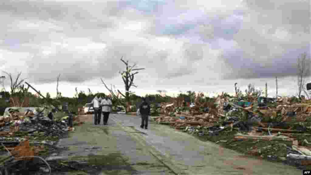 Residents search through what is left of their homes after a tornado hit Pleasant Grove just west of downtown Birmingham a day earlier, on Thursday, April 28, 2011, in Birmingham, Ala. (AP Photo/Butch Dill)