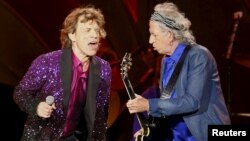 FILE - British veteran rockers The Rolling Stones lead singer Mick Jagger sings next to band member Keith Richards, as they open their North American "Zip Code" tour in San Diego, California, May 24, 2015. 