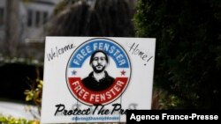 A ground sign in support of US journalist Danny Fenster reads "welcome home!" after he was freed and on his way home after spending nearly six months in jail in military-ruled Myanmar, on Nov. 15, 2021 in West Bloomfield, Michigan.