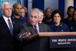 Dr. Anthony Fauci, director of the National Institute of Allergy and Infectious Diseases, with Vice President Mike Pence behind him, speaks during a briefing about the coronavirus at the White House, March 15, 2020