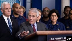 Dr. Anthony Fauci, director of the National Institute of Allergy and Infectious Diseases, with Vice President Mike Pence behind him, speaks during a briefing about the coronavirus in the James Brady Press Briefing Room of the White House, March 15, 2020, 