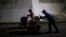 Joel Eduardo Espinar, foreground, and his wife, Yamilet Hernandez, push baby strollers as they start early in the morning toward Arriaga from Pijijiapan, Mexico, Oct. 26, 2018.