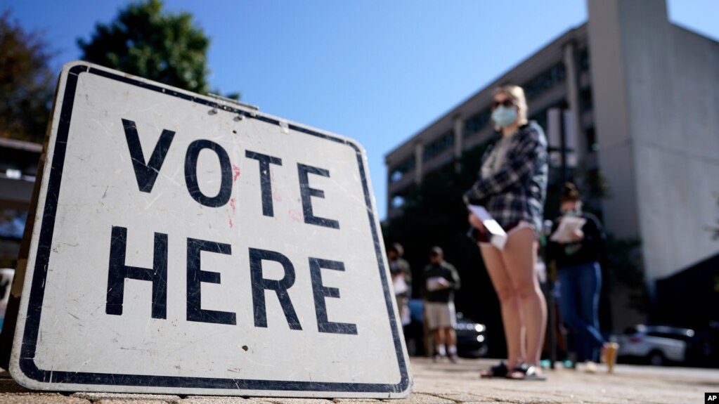 Voters stand in a line as they wait to vote early in Athens, Ga, Oct. 19, 2020. (AP)