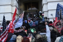 U.S. President Donald Trump's supporters clash with police and security forces as they storm the Capitol in Washington, D.C., Jan. 6, 2021.