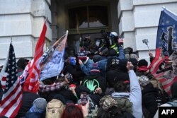 FILE - Trump supporters clash with police and security forces as they storm the U.S. Capitol in Washington, Jan. 6, 2021.