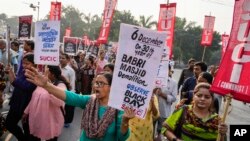 FILE - Activists of Socialist Unity Center of India-Communist shout slogans during a protest to mark the anniversary of Babri Mosque demolition in Kolkata, India, December 6, 2022.