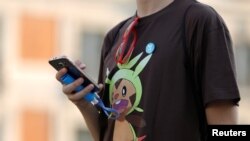 A young man's T-shirt gives him away — he's a Pokemon fan. 
