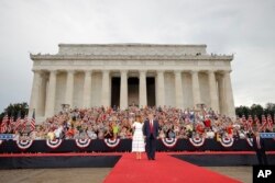 President Donald Trump and first lady Melania Trump arrive at an Independence Day celebration in front of the Lincoln Memorial, Thursday, July 4, 2019, in Washington.