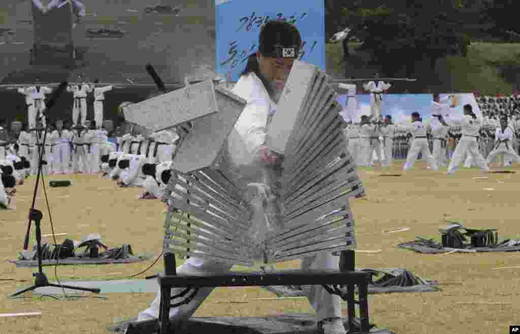 A soldier from the South Korean army special forces breaks stone plates during a rehearsal for the 67th anniversary of Armed Forces Day at the Gyeryong military headquarters in Gyeryong. Seoul will celebrate the 67th Armed Forces Day on Oct. 1.