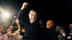 Tunisian presidential candidate and media mogul Nabil Karoui, waves as he is greeted by jubilant crowds after he was released from prison in Mannouba, Tunisia, Wednesday Oct. 9, 2019, just four days before the upcoming presidential runoff election. 