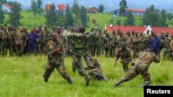 M23 soldiers demonstrate unarmed combat at Rumangabo military camp, North Kivu April 27, 2013. Rebels are honing their ambush skills to prepare to face a new United Nations force which has a mandate to go on the offensive. 