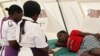 FILE: A woman is attended to after suffering from a suspected case of typhoid at a local hospital in Harare, January 31, 2012.