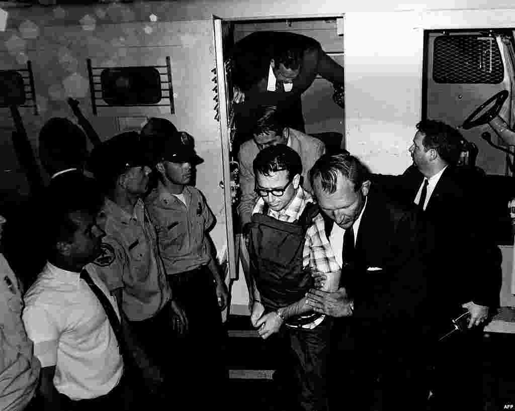 This 1968 photo released by the Shelby County Register's office on March 31, 2011 shows James Earl Ray being transported in Memphis, Tennessee. (REUTERS/Shelby County Register of Deeds)