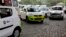 Ola cabs, left, waiting for customers, are parked next to other cars in Kolkata, India, March 29, 2016.