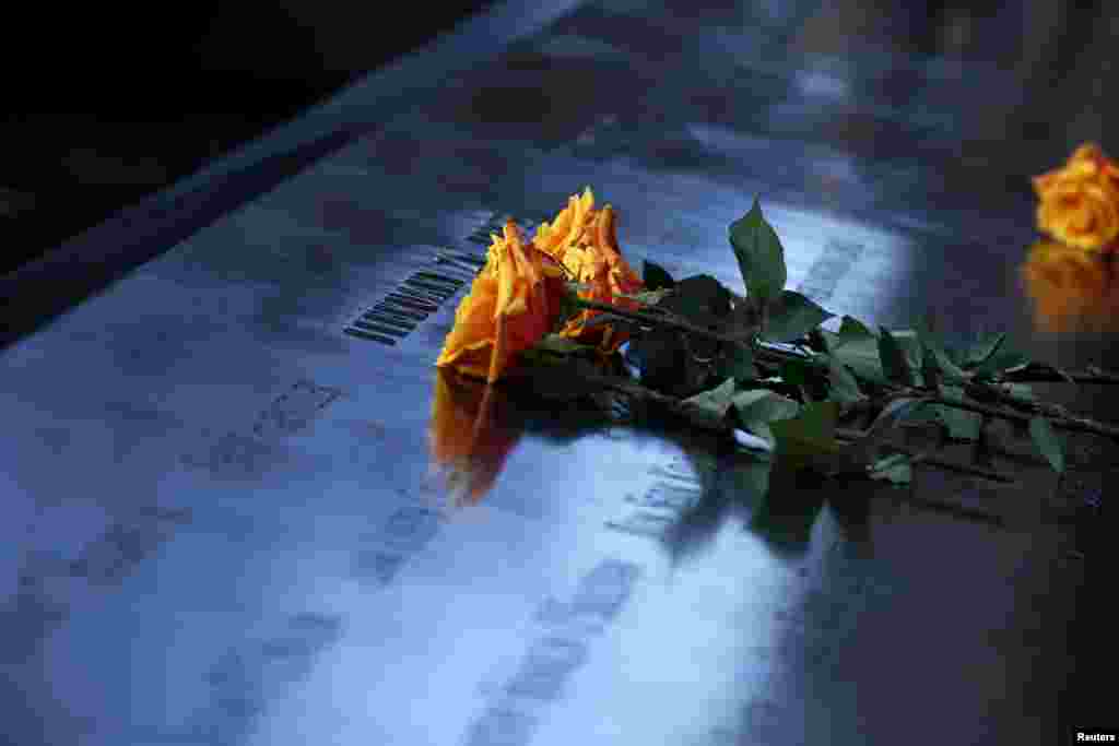 Flowers are seen on the reflecting pool of the 9/11 Memorial during a commemoration ceremony marking the 23rd anniversary of the 1993 World Trade Center bombing in New York.