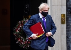 Britain's Prime Minister Boris Johnson leaves Downing Street in London, Britain, Dec. 2, 2020.