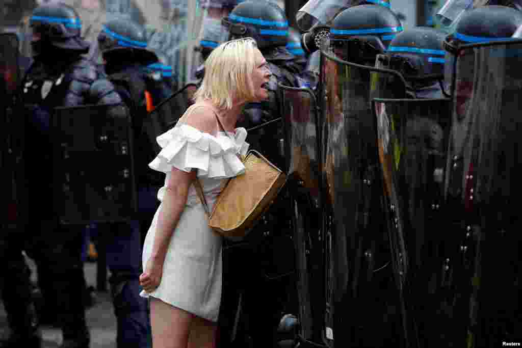 A protester confronts riot police officers during a demonstration against COVID-19 restrictions, including compulsory health passes, in Paris, France, Sep. 11, 2021. 