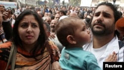 FILE - Alaa Abdel Fattah arrives with his wife and child to the public prosecutor's office in Cairo, March 26, 2013. 