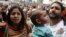 FILE - Alaa Abdel Fattah arrives with his wife and child to the public prosecutor's office in Cairo, March 26, 2013. 