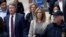 Felicity Huffman, center, departs federal court with her brother Moore Huffman Jr., left, May 13, 2019, in Boston, where she pleaded guilty to charges in a nationwide college admissions bribery scandal. 