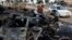 A man walks past the site of car bomb attack in Buhriz, northeast of Baghdad, Dec. 9 2013. 