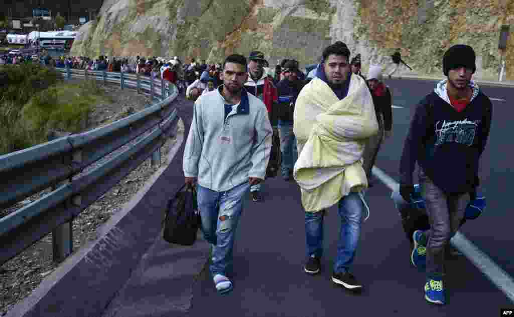 Venezuelans heading to Peru walk along the Panamerican highway in Tulcan, Ecuador, after crossing from Colombia. Ecuador announced that Venezuelans entering the country would need to show passports from Aug. 18 onwards, a document many are not carrying. And Peru followed suit, announcing an identical measure due to begin on Aug. 25.