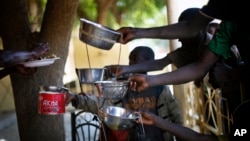 Children get their food from leftovers at a restaurant in Gao, northern Mali, Feb. 8, 2013.