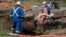 Emergency crews work to clean up an oil spill near Interstate 40 in Mayflower, Arkansas. An Exxon Mobil pipeline carrying Canadian crude oil was shut off after a ruptured on Friday causing an evacuation of 22 homes, Mar. 31, 2013.