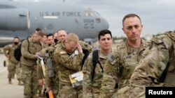 Military personnel from the 82nd Airborne Division and 18th Airborne Corps board a C-17 transport plane for deployment to Eastern Europe, amid escalating tensions between Ukraine and Russia, at Fort Bragg, North Carolina, Feb. 3, 2022. 