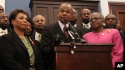 FILE - Rep. Barbara Lee, D-Calif., Rev. Calvin Butts, and Rep. Alcee Hastings, D-Fla., are joined at podium by other church and community leaders from New York, on Capitol Hill in Washington, Wednesday, March 17, 2010.