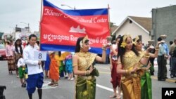 Cambodian traditional dancers give blessing during an annual parade in the designated 'Cambodia Town' section of Long Beach, California, on April 2, 2011, to celebrate Khmer New Year.