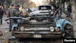 People gather at a site of a car bomb blast in Damascus, Syria, Jan. 24, 2019.