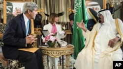 U.S. Secretary of State John Kerry, left, and King Abdullah wait for a meeting at the King's private residence in the Red Sea city of Jeddah, Saudi Arabia, June 27, 2014