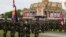 Cambodian Army soldiers stand as they practice in front of Royal Palace ahead of the country's 65th Independence Day, in Phnom Penh, Cambodia, Wednesday, Nov. 7, 2018. (AP Photo/Heng Sinith)