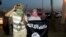 A fighter of the Islamic State of Iraq and the Levant (ISIL) holds a weapon while another holds a flag in the city of Mosul, June 23, 2014. 