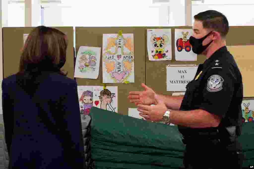 Vice President Kamala Harris looks at pictures drawn by children as she visits the Paso del Norte (PDN) Port of Entry in El Paso, Texas, June 25, 2021. 