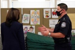 Vice President Kamala Harris looks at pictures drawn by children as she visits the Paso del Norte (PDN) Port of Entry in El Paso, Texas, June 25, 2021.