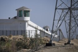 FILE - Watchtowers are seen on a high-security facility near what is believed to be a re-education camp where mostly Muslim ethnic minorities are detained, on the outskirts of Hotan, in China's northwestern Xinjiang region, May 30, 2019.