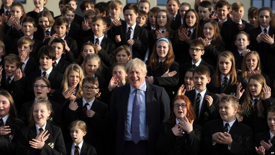 The Chulmleigh College school choir sings and signs 'A Lovely Day' as Britain's Prime Minister and Conservative Party leader, Boris Johnson visit in Chulmleigh, England, Nov. 28, 2019, ahead of the general election on Dec. 12. 