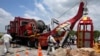 Rescue workers hoist up a cage that was used to rescue trapped people at an abandoned gold mine, in Stilfontein, South Africa, Jan. 16, 2025.