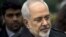 FILE - Iranian Foreign Minister Javad Zarif is seen as he walks through a courtyard at the Beau Rivage Palace Hotel during an extended round of talks in Lausanne, April 1, 2015. 