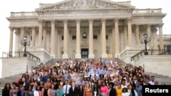 A group of Democrat Capitol Hill interns pose on the east steps of the U.S. Capitol in Washington, July 19, 2016.