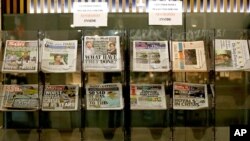 Newspapers headlining Prince Harry and Meghan’s explosive TV interview are displayed for sale outside a shop in London, March 9, 2021. 