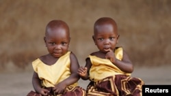 Identical twins Taiwo Adejare and Kehinde Adejare pose for a picture in Igbo Ora, Oyo State, Nigeria April 4, 2019. Picture taken April 4, 2019. REUTERS/Afolabi Sotunde