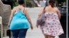 FILE - Two women cross the street in Barre, Vermont, June 17, 2013.