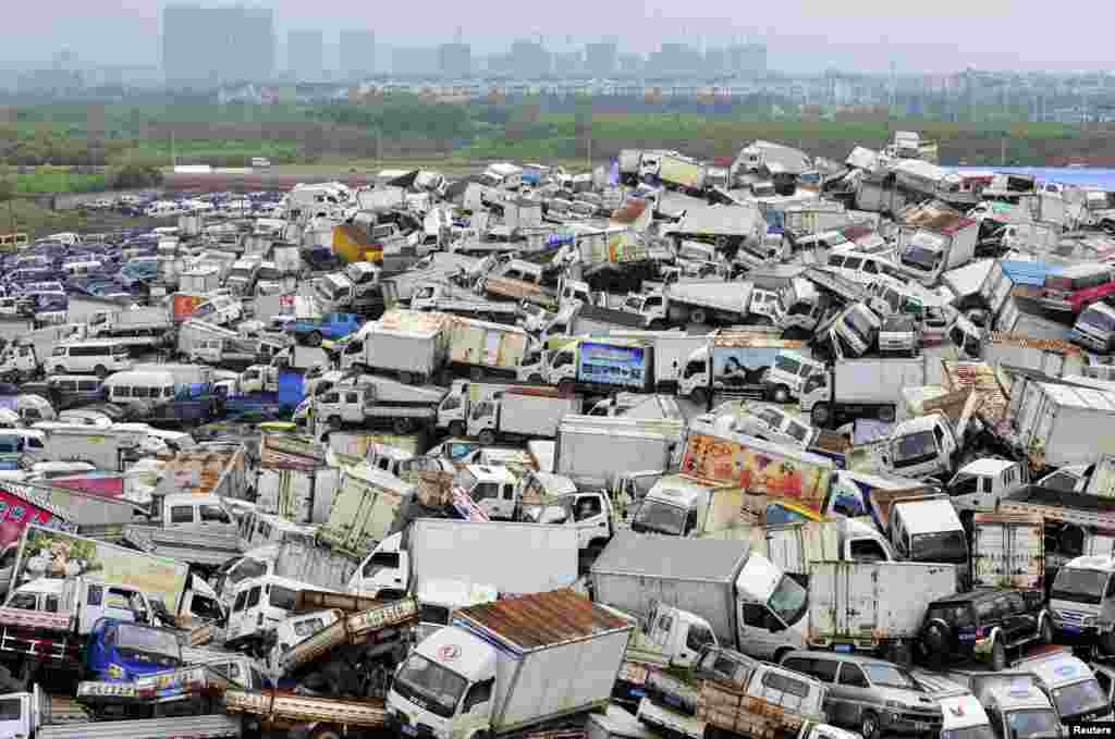 Scrapped high-emission vehicles are piled up at a dump site of a recycling center in Yiwu, Zhejiang province, China, April 8, 2015.