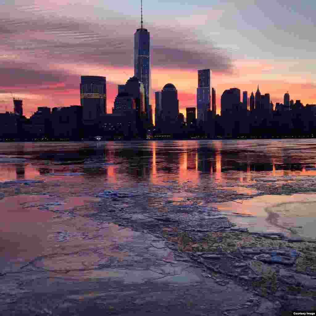 The beautiful tones of the morning sunrise over lower Manhattan as reflected in the icy waters of the Hudson river made waiting outside in the frosty 7&deg; C air all worth it! (Photo taken by Daniel Leavey of Jersey City in New Jersey on Feb. 21, 2015)